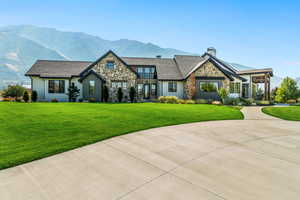 View of front of home featuring a front lawn and a mountain view