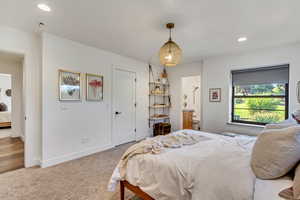 Bedroom featuring carpet flooring and connected bathroom