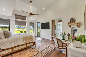 Master Bedroom featuring ceiling fan, high vaulted ceiling, multiple windows, and access to outside