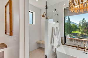 Master Bathroom with a healthy amount of sunlight and separate shower and tub