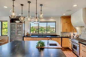 Kitchen with a wealth of natural light, high end stove, and sink