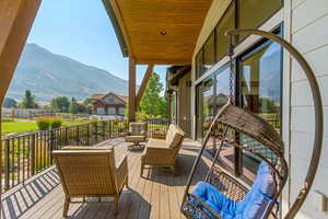 Wooden deck with outdoor lounge area and a mountain view