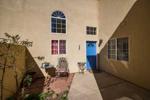 Entrance to property featuring a patio and stucco siding