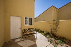 Property entrance featuring stucco siding, a patio, and a tiled roof