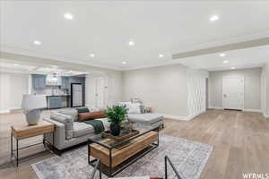 Living room featuring indoor wet bar and light hardwood / wood-style flooring