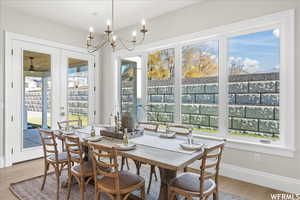 Dining space with wood-type flooring and an inviting chandelier