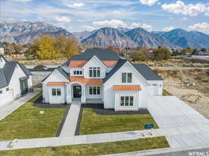 Modern farmhouse style home with a mountain view and a front yard