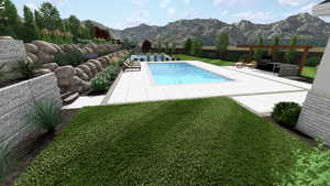 View of swimming pool featuring a patio, a mountain view, and a yard