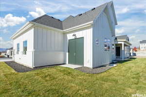 Rear view of house with a yard