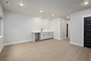 Interior space with light wood-type flooring and sink