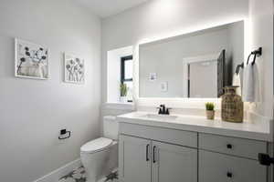 Bathroom featuring vanity and toilet