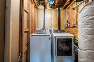 Clothes washing area featuring separate washer and dryer