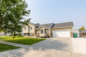 View of front of house with a front lawn and a garage