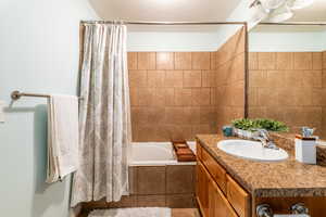 Bathroom featuring shower / tub combo and vanity