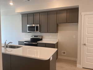 Kitchen with shaker cabinets and quarz counters.