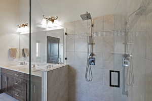 Bathroom featuring vanity and a shower with shower door