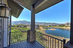 Wooden deck featuring a water and mountain view