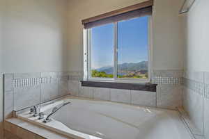 Bathroom featuring a mountain view and tiled bath