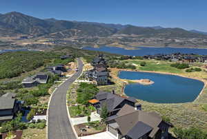 Drone / aerial view featuring a water and mountain view