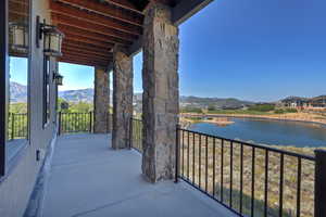 Balcony featuring a water and mountain view