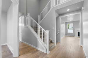 Stairs featuring hardwood / wood-style floors