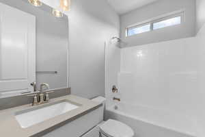 Full bathroom featuring vanity, toilet, and bathtub / shower combination