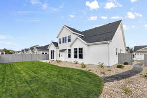 Rear view of property featuring a lawn