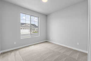 Unfurnished room featuring light colored carpet