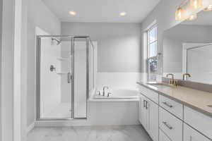 Bathroom with vanity and shower with separate bathtub