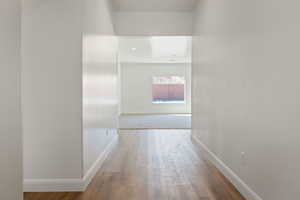 Hall with light hardwood / wood-style flooring