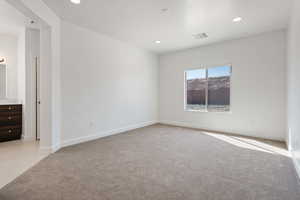 Empty room with light colored carpet