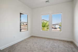 Unfurnished room featuring light carpet