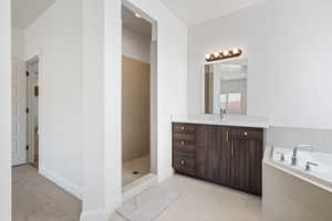 Bathroom featuring vanity, independent shower and bath, and tile patterned floors