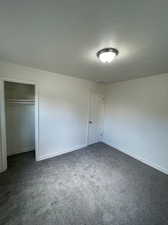 Unfurnished bedroom with a closet and carpet floors