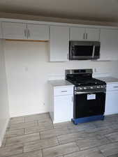 Kitchen featuring white cabinets and stainless steel appliances