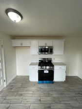 Kitchen with white cabinets and stainless steel appliances