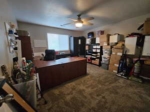 Office space featuring ceiling fan, a textured ceiling, and carpet floors