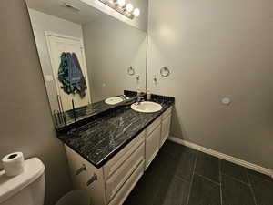 Bathroom featuring vanity and toilet