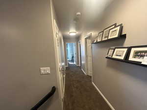 Corridor with dark colored carpet