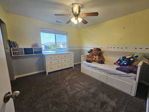 Bedroom featuring dark carpet and ceiling fan