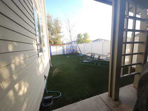 View of yard featuring a playground and a patio