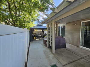 View of patio featuring a gazebo and an outdoor hangout area