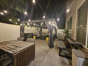 View of patio with an outdoor fire pit