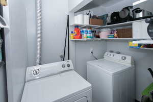 Clothes washing area featuring separate washer and dryer