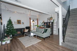 Living room featuring a textured ceiling and dark wood-type flooring