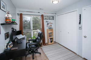 Office area featuring hardwood / wood-style floors and a textured ceiling