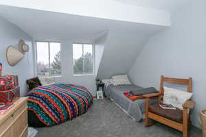 Carpeted bedroom featuring a textured ceiling