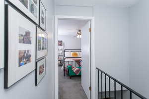 Hallway featuring carpet and a textured ceiling