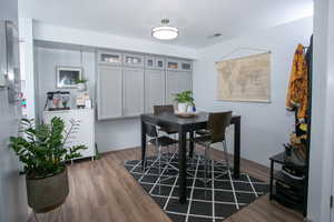 Dining area with hardwood / wood-style flooring