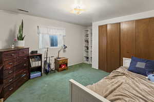 Bedroom featuring a closet and carpet floors